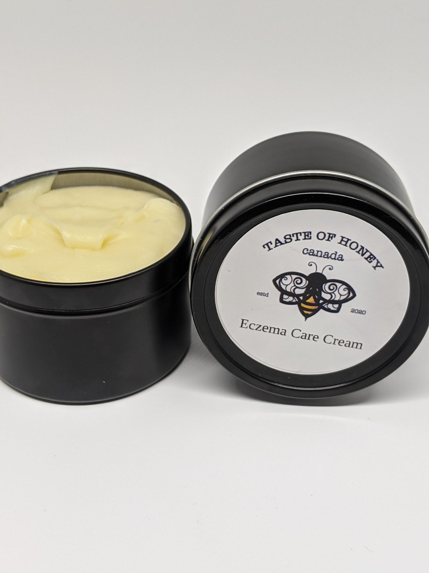 Eczema Care Body Butter.  Black tin, white label with bee logo